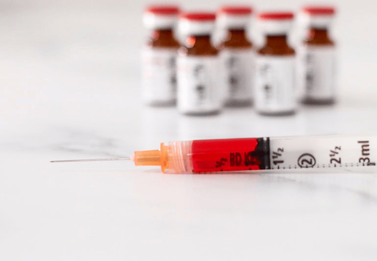 Vitamin B12 injection supplies including vials and a shot setup