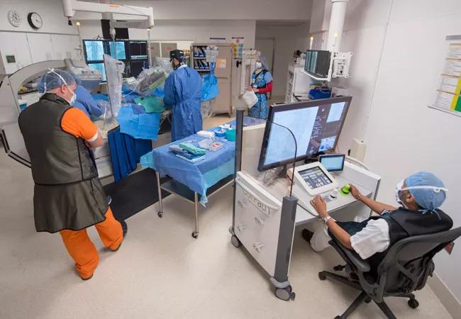 Dr. Khatri seated in the cockpit of the robotic system during a case.