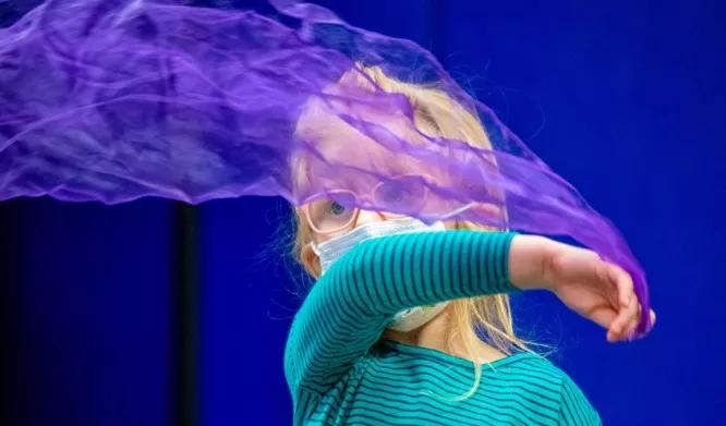 Little girl with green shirt and purple scarf