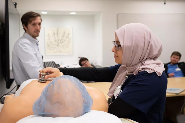 Students performing medical simulations in preparation for residency.