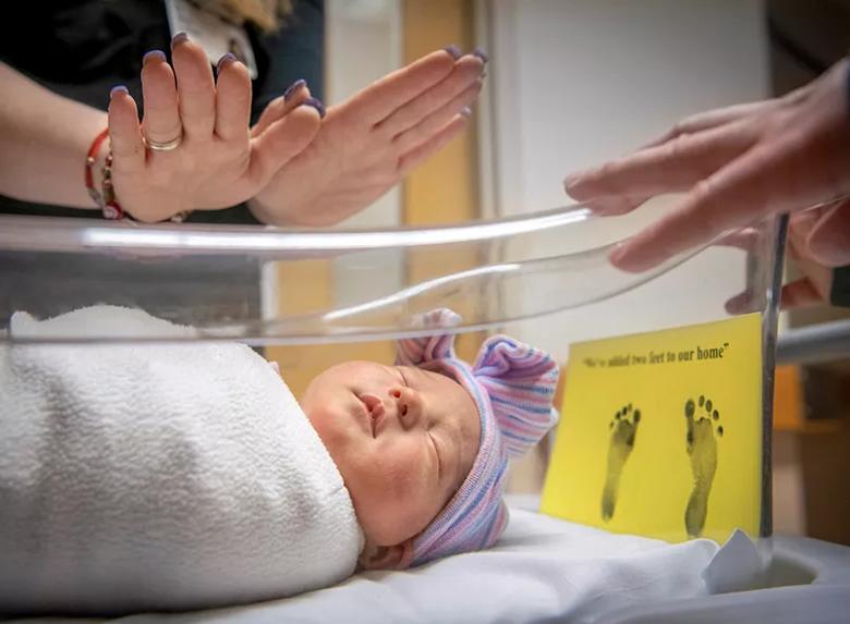Hands blessing newborn
