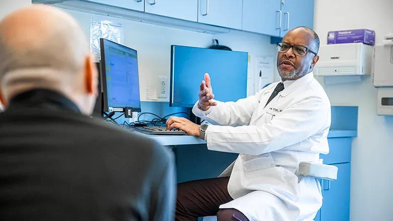 A Cleveland Clinic Caregiver talking with a patient