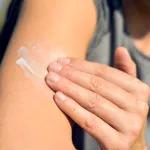 Applying sunscreen to arm