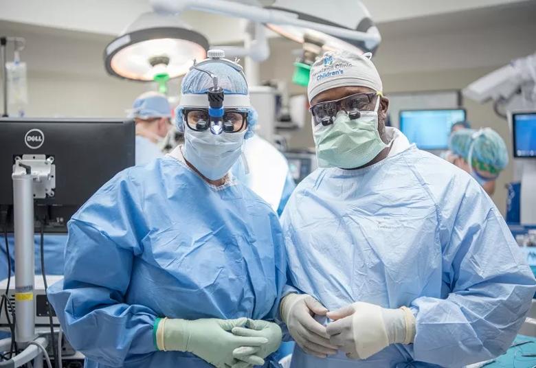 Drs. Recinos and Onwuzulike pause after completing the myelomeningocele repair.