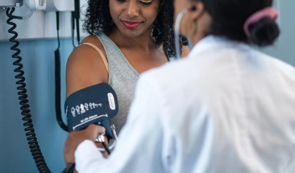 Young woman in medical consultation with female doctor