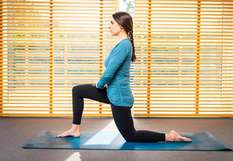 person on yoga mat in low lunge pose