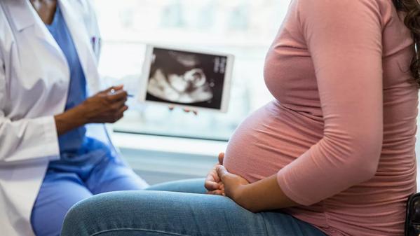 provider showing ultrasound to woman