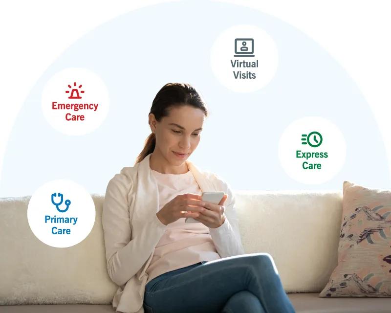 Person sitting on a couch looking at their mobile phone.