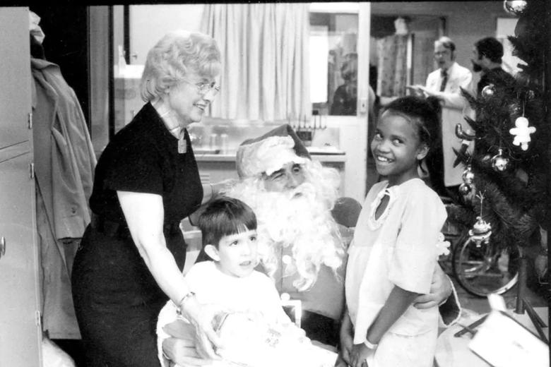 Lorraine Felmlee with patient Brian Seifert at left; Lola Stevens at right telling her wishes to Santa Claus.
