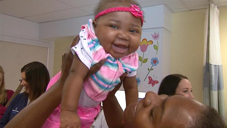 Smiling baby upon discharge from hospital after transplant