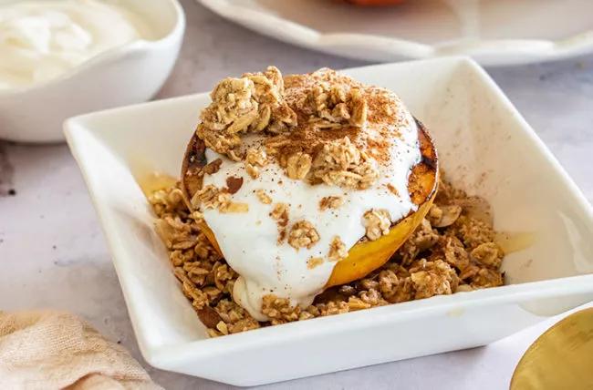 An image of grilled peaches with cinnamon honey yogurt dip.