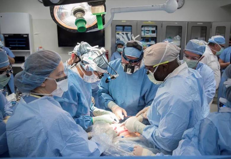 Surgical team members consult as they prepare to repair the myelomeningocele lesion.