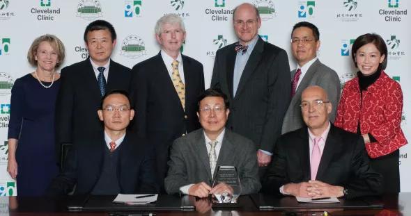 Photo of key players at the Cleveland Clinic/Peking Union Medical College Hospital (PUMCH) consortium signing ceremony. Standing (left to right): Abby Abelson, MD, Chair, Cleveland Clinic Department of Rheumatic and Immunologic Diseases; Qingping Yao, MD, PhD, a Cleveland Clinic rheumatologist; William Carey, MD, Director, Cleveland Clinic Center for Continuing Education; James Stoller, MD, Chair, Cleveland Clinic Education Institute; Cleveland Clinic gastroenterologist Bo Shen, MD; and Cleveland Clinic rheumatologist M. Elaine Husni, MD, MPH. Sitting (left to right): PUMCH physician Xuan Zhang, MD; Feng-Chun Zhang, MD, Chair, Department of Medicine, PUMCH; and Leonard Calabrese, DO, Director, R.J. Fasenmyer Center for Clinical Immunology. 