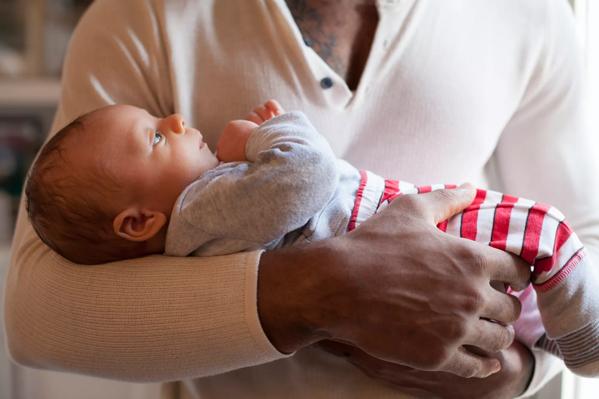 Father holding his newborn baby in his arms