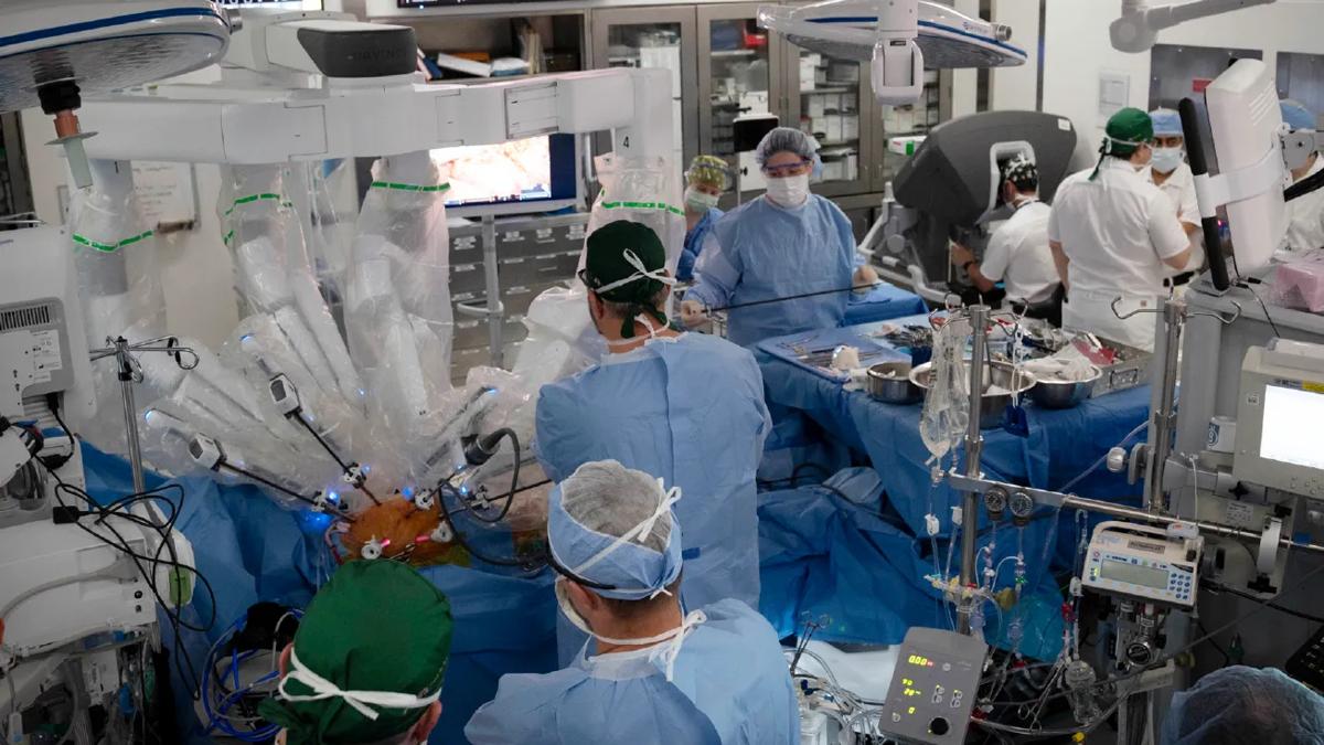 operating room with robotic arms in the patient on the operating table