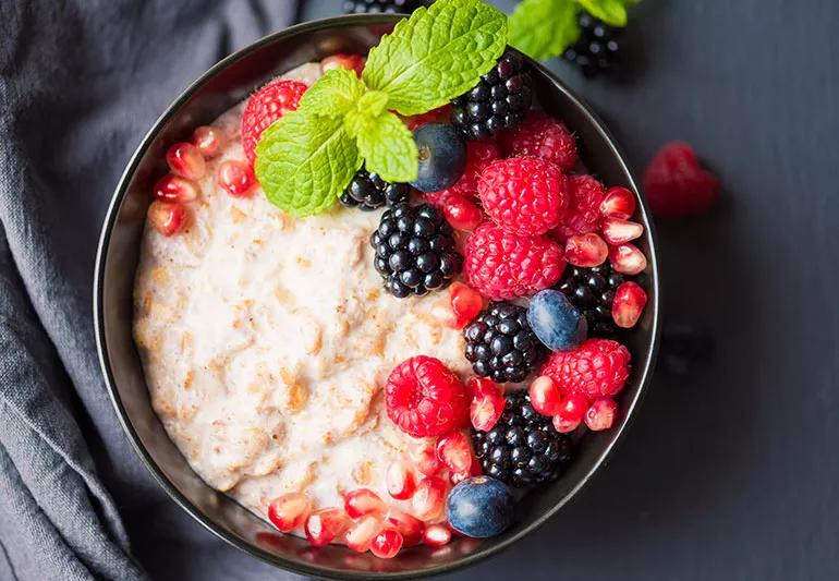 Bowl of overnight oats with berries and mint