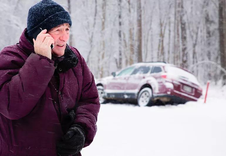 Man calling for help after his car goes off the road during winter driving