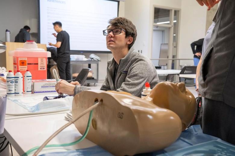 Students performing medical simulations in preparation for residency.