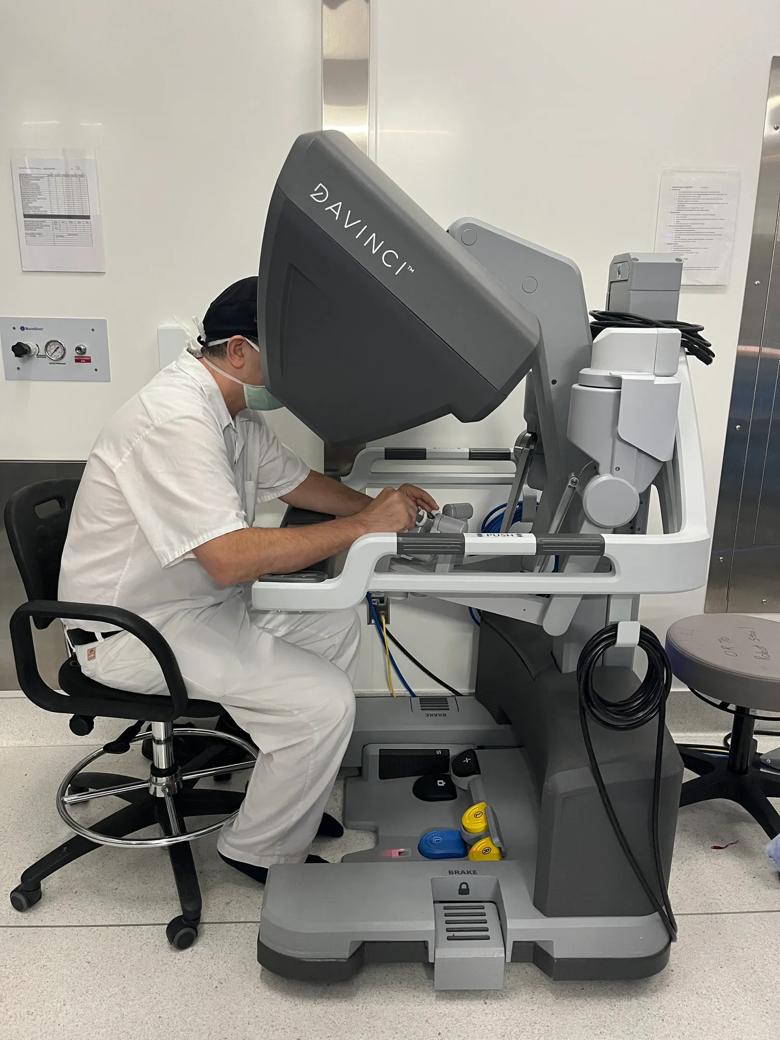 surgeon seated at robotic surgery console