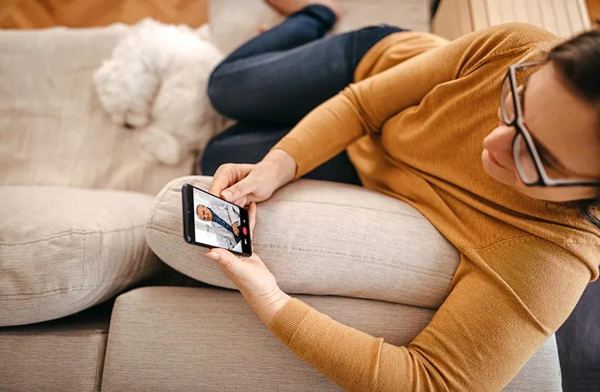 A person having a virtual visit with a doctor on their phone