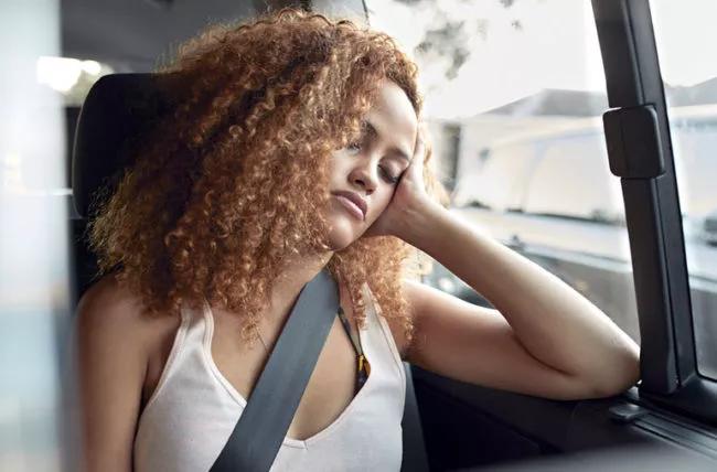 A person sleeping in the car.