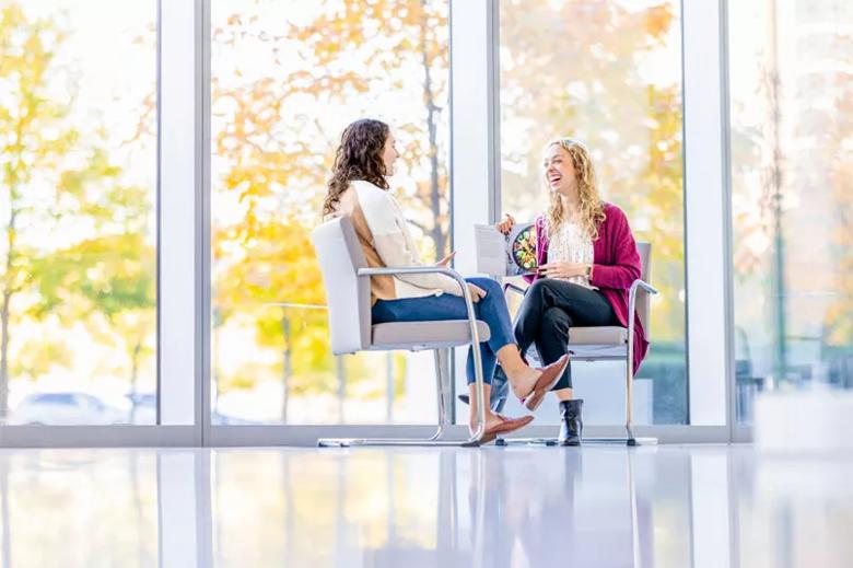 Women discussing nutrition in chairs indoors