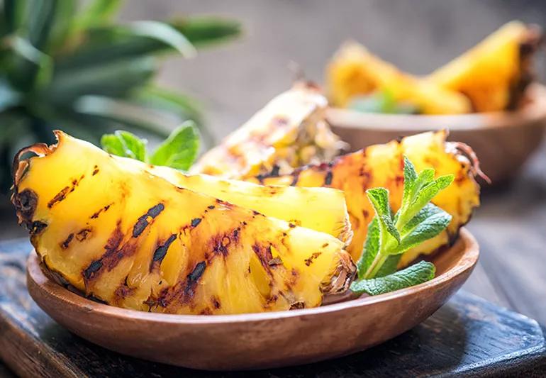 bowl with quartered pineapple with grill marks