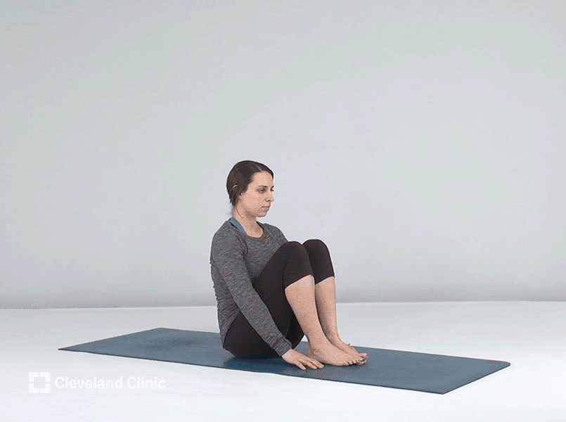 Person doing yoga boat pose