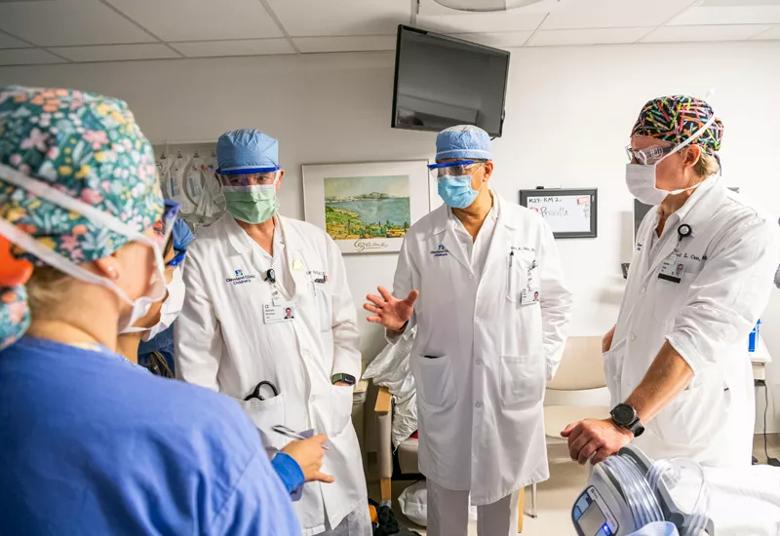 Members of the surgical team confer before the procedure begins.