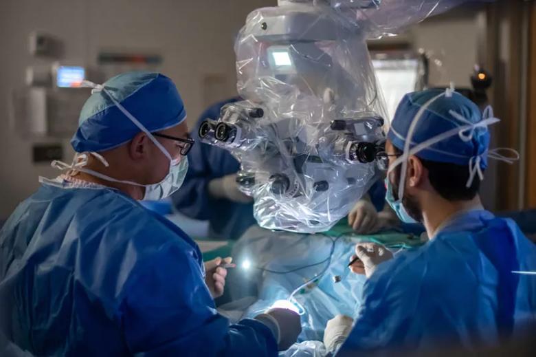 Two surgeons operating on a patient's eye