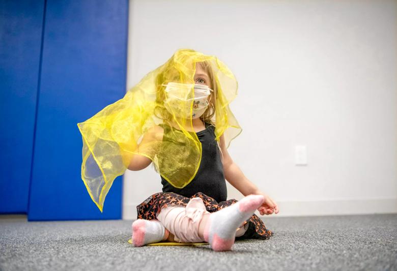 Girl with yellow scarf covering head