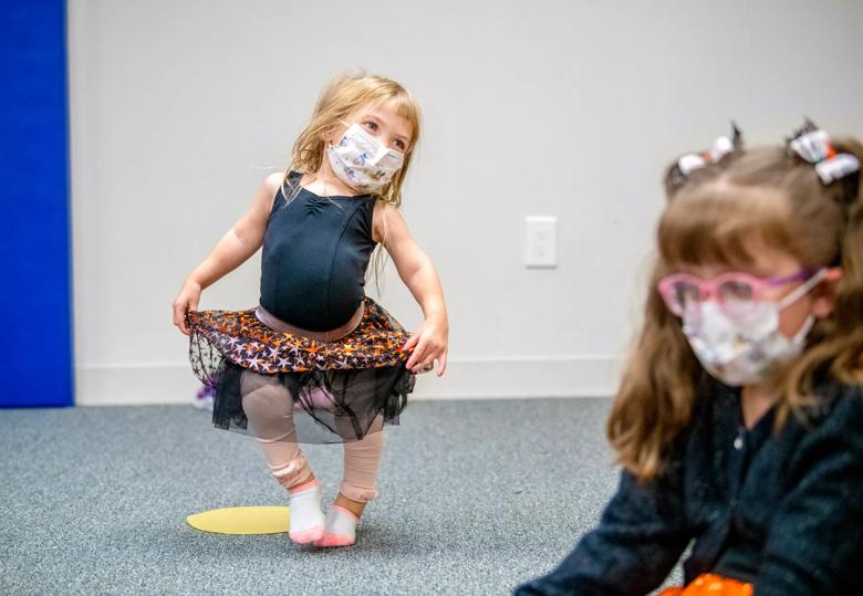 Little girl holding skirt and pointing toe