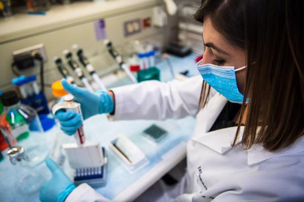 A researcher conducts a breast cancer vaccine related experiment in a lab at Cleveland Clinic.