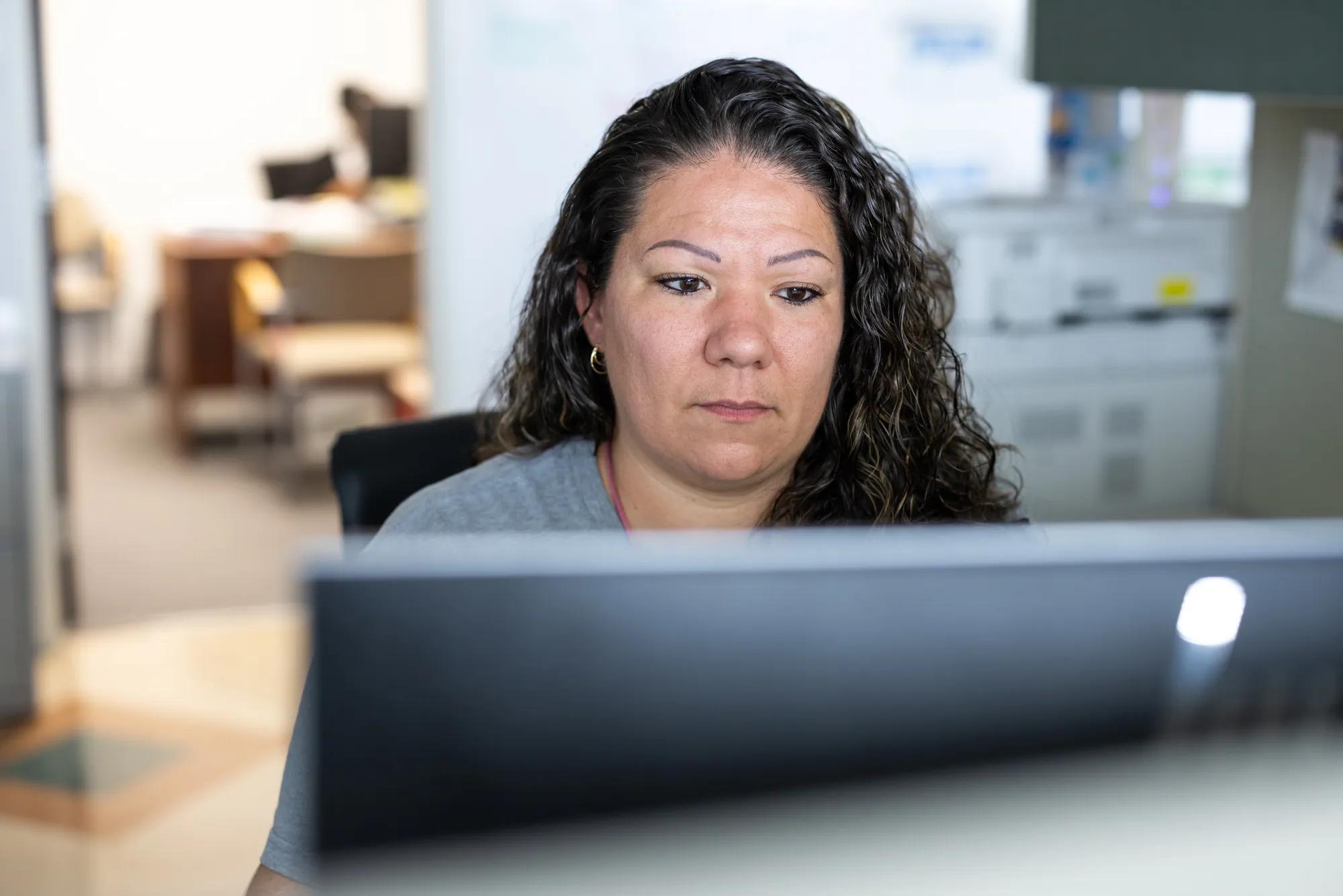 Woman typing on computer.