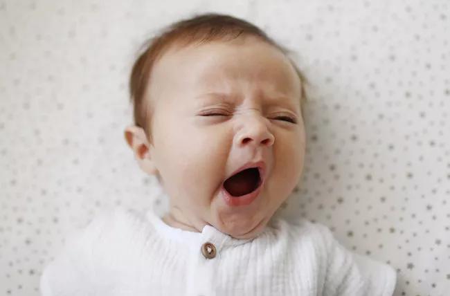 An infant yawning.
