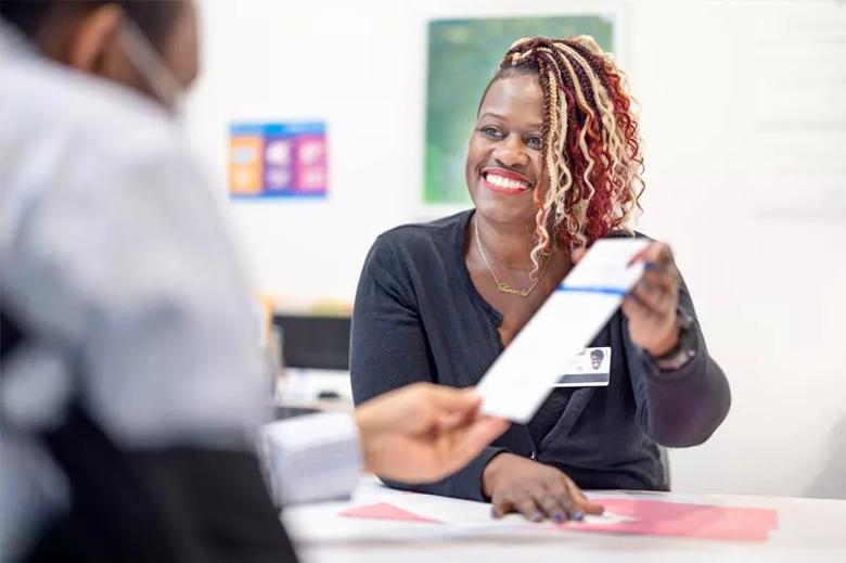 Woman shares pamphlet with patient