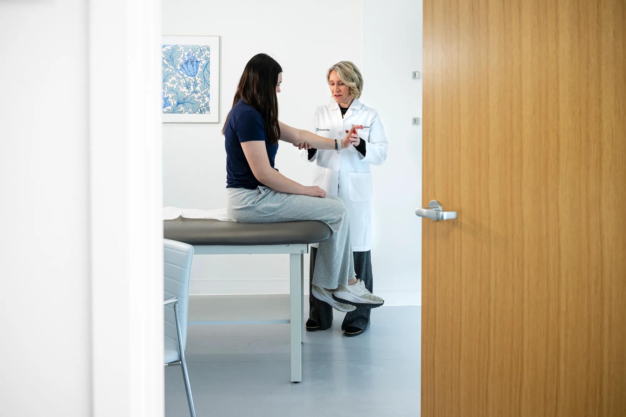 Cleveland Clinic doctor examining a patient's arm