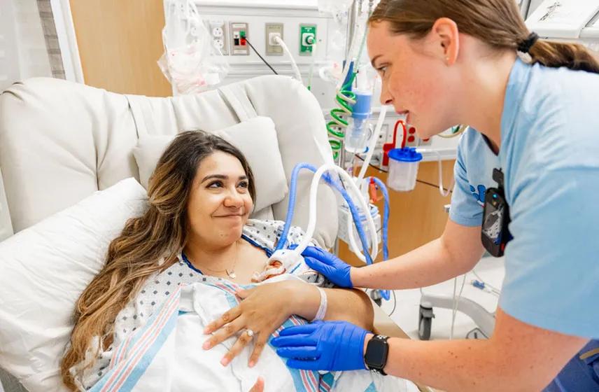 Caregiver and patient in an exam room.
