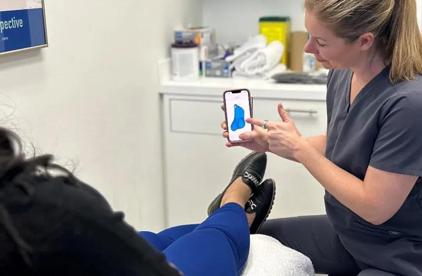 Feet being massaged to demonstrate pain and discomfort in the arch and heel.