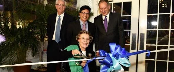 Pauline Braathen cuts the ribbon to the entrance of the new building, joined by (L to R) Steven Roshon, MD, Nestor Galvez-Jimenez, MD, and CEO Toby Cosgrove, MD