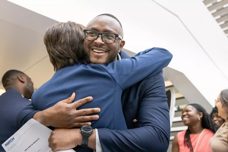CCLCM students excitedly hugging.