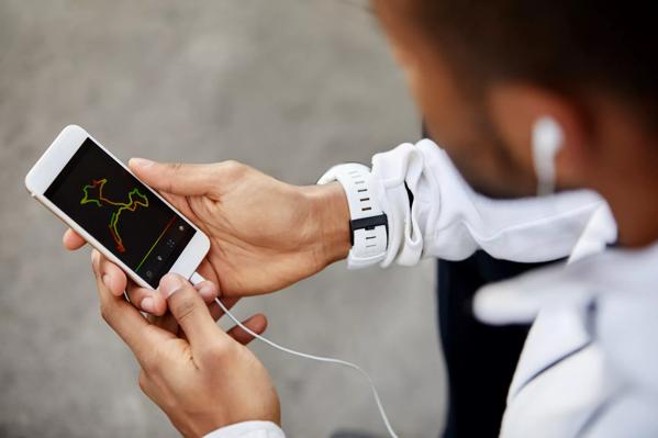 Man looking at analysis on screen of smart phone