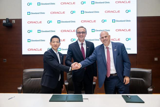 Cleveland Clinic President and CEO Tom Mihaljevic, M.D., (center) with representatives of G42 and Oracle.