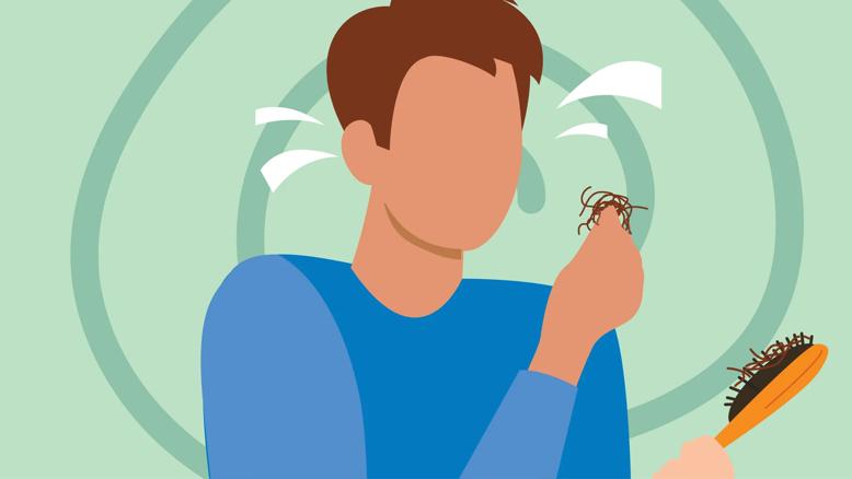 Concerned person holding handful of hair with extra hair in the brush