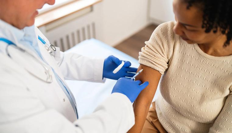 A person getting a flu shot from a healthcare provider