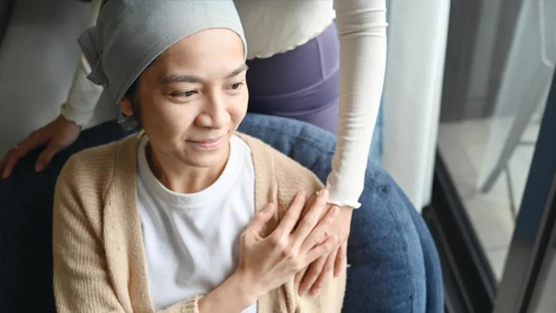 Patient holding loved one's hand