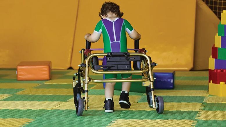 small child walking with a wheeled walker
