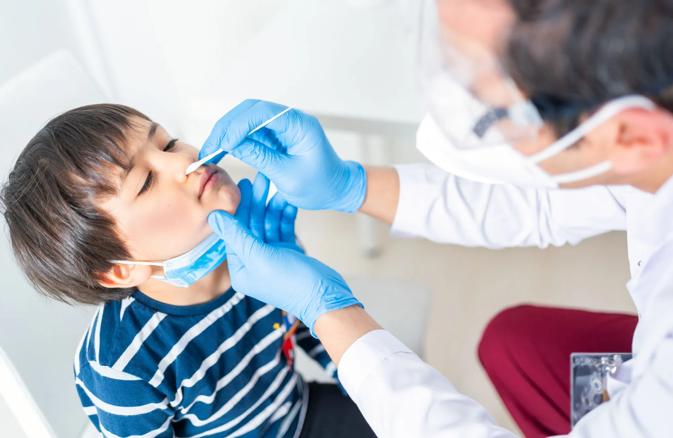 boy receiving nasal swap for covid test