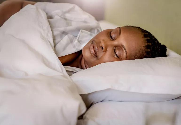 woman sleeping in cozy bed