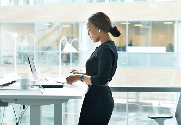 Woman writing down her priorities so she can figure out which things to say no to.